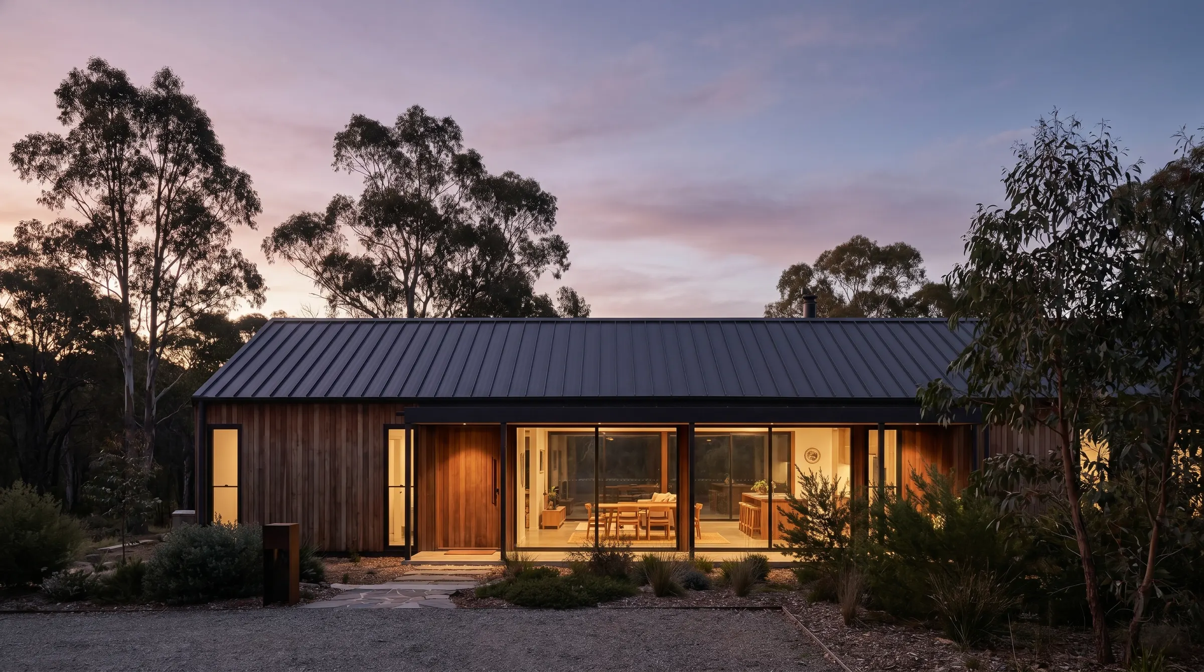 A luxury modern Canberra home at dusk among the gum trees